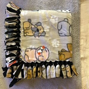 50x60” fleece tie blanket.  Puppy pattern fleece with black fleece backing.